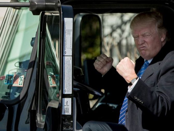 Donald Trump sits in a truck, pretends to be big man. 